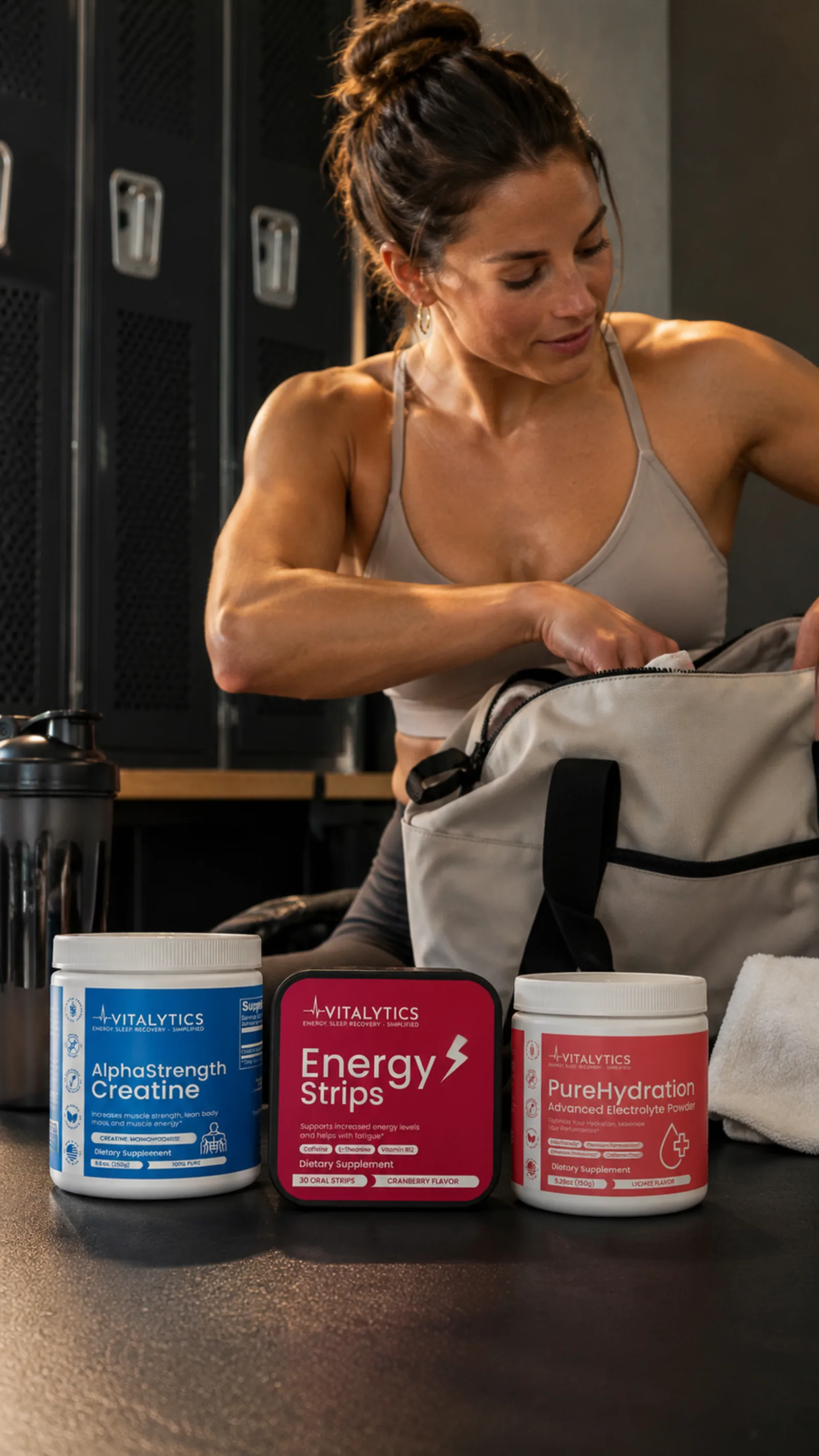 Woman packing a gym bag with Vitalytics products lined up in front of her.